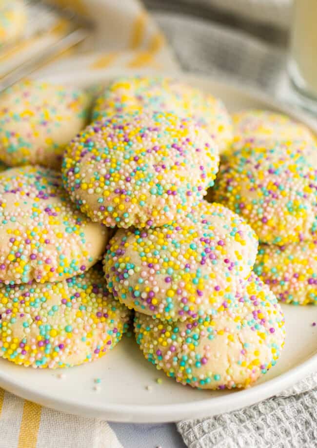 stacked sprinkle cookies on white plate
