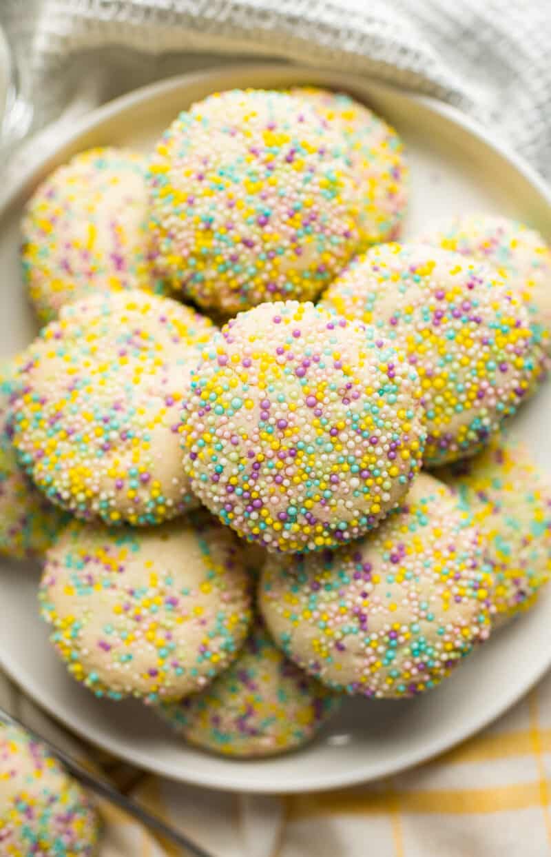 overhead stacked sprinkle cookies on white plate