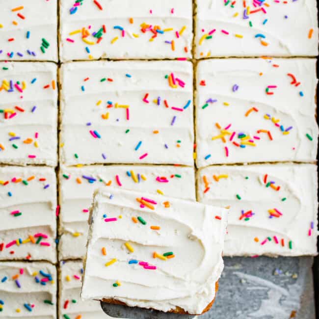 sliced vanilla sheet cake with frosting and sprinkles