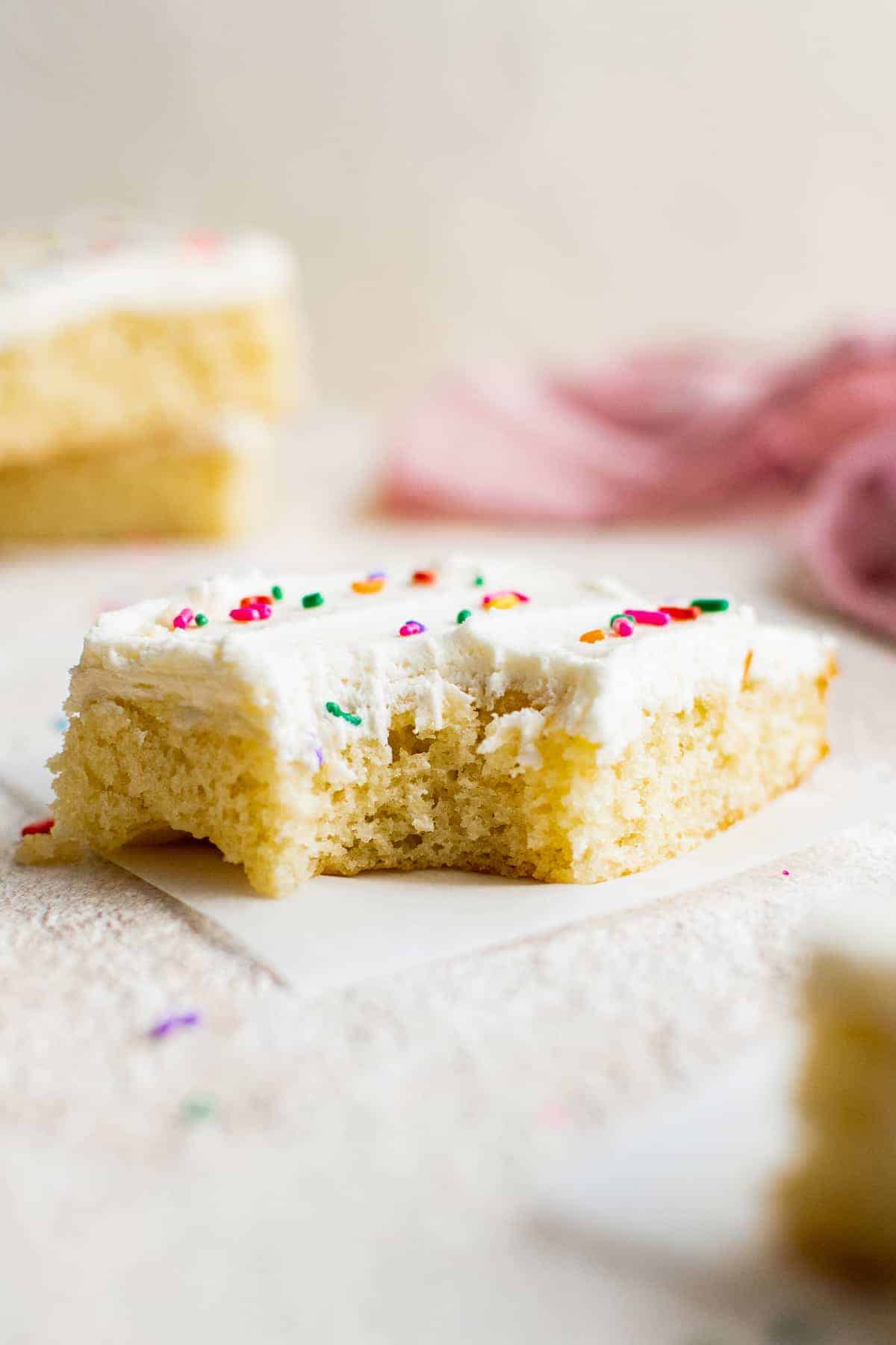 bite out of frosted vanilla sheet cake