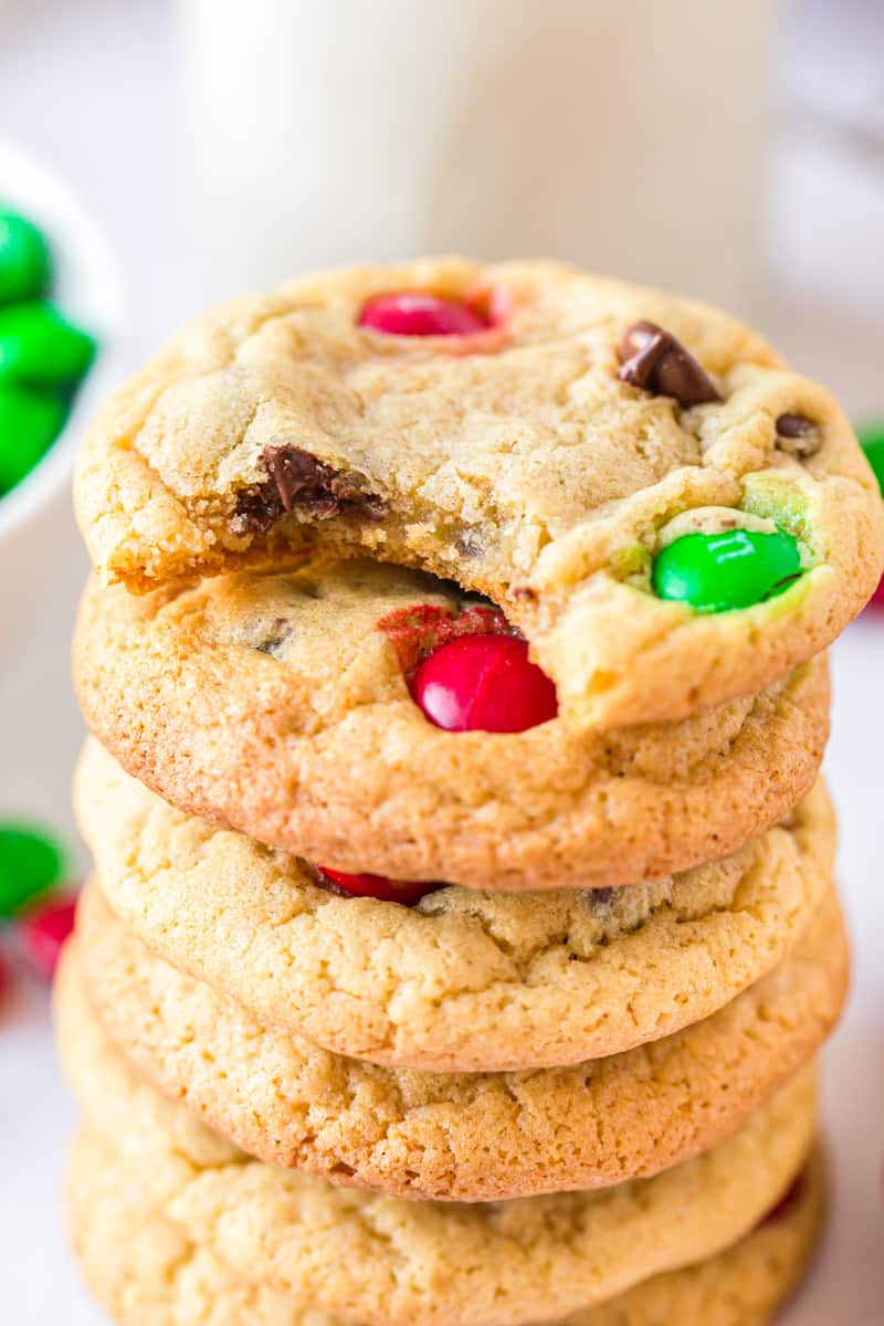 stack of christmas M&M cookies with a bite taken from one