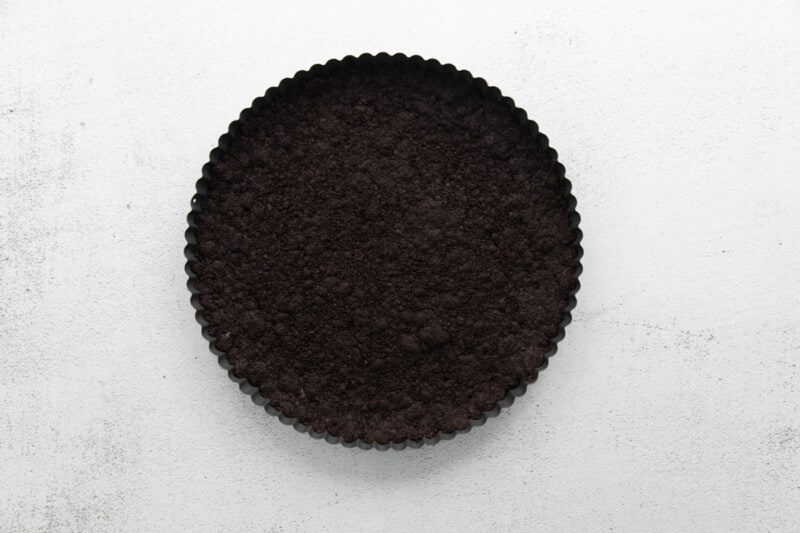 chocolate tart crust pressed into a round tart dish.