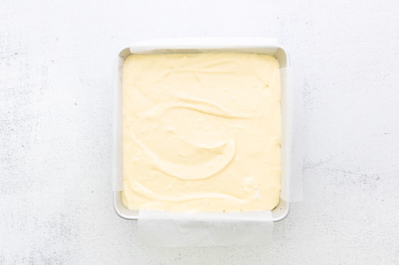cheesecake batter in a square baking pan
