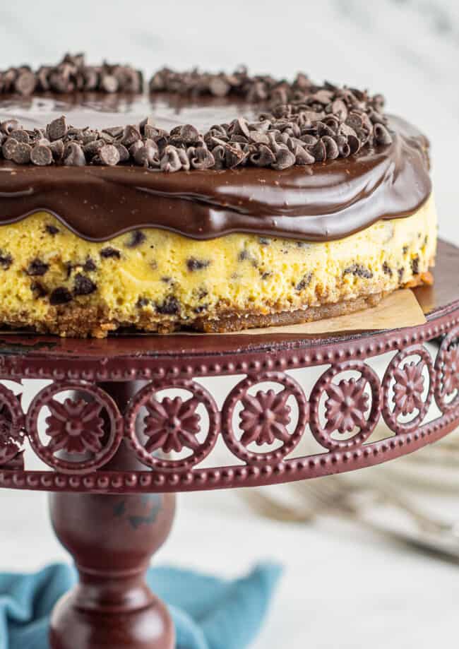 up close chocolate chip cheesecake on cake stand