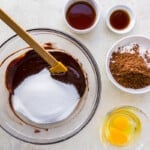 sugar and chocolate mixture in a glass bowl with a spatula