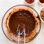 brownie batter in a glass bowl with beaters
