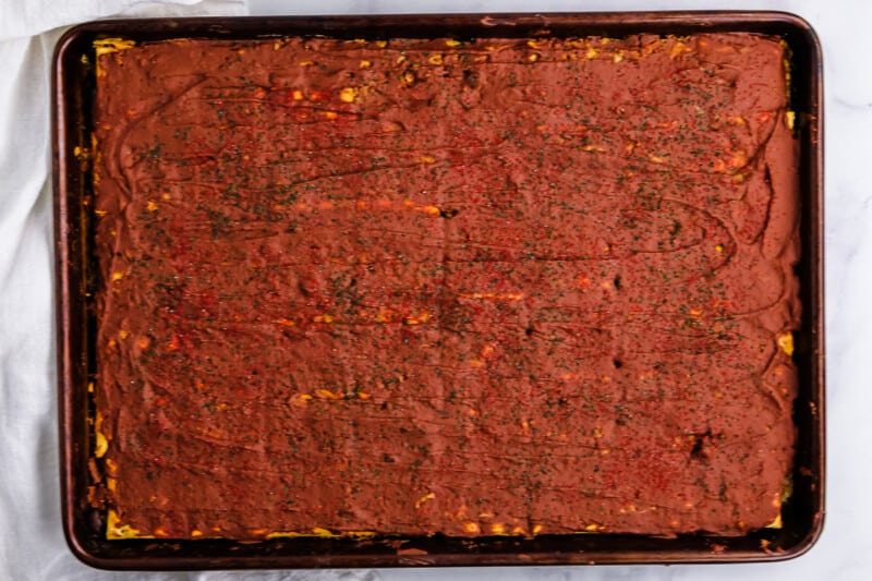 a baking pan with a square of brownies on it.