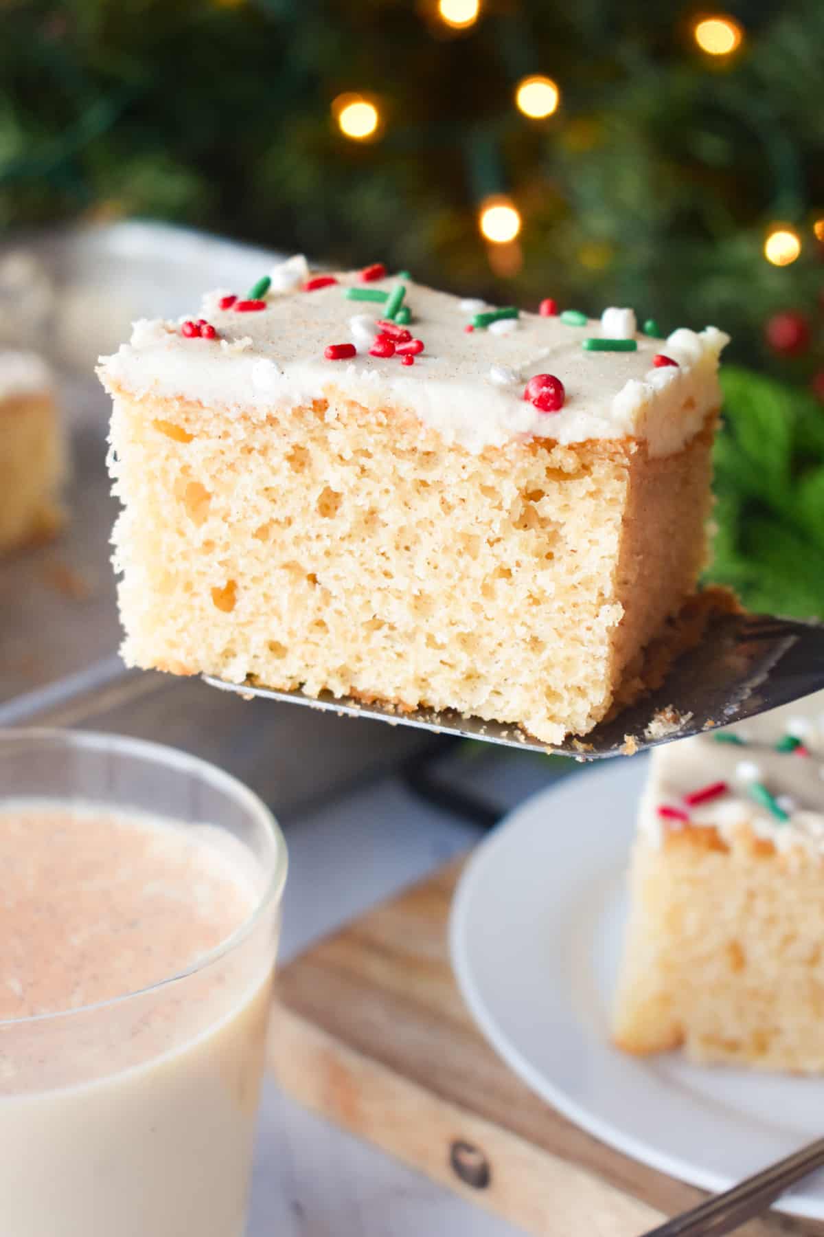 a slice of eggnog sheet cake on a spatula.