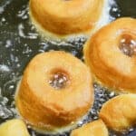 cinnamon sugar donuts being fried.