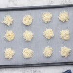 unbaked coconut macaroons on a baking sheet.