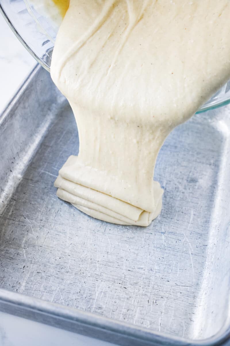 eggnog sheet cake batter poured into a greased 9x13 pan.