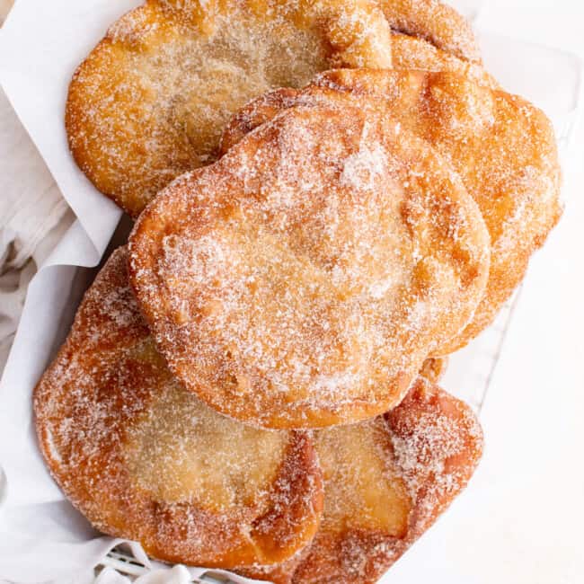 overhead view of elephant ears pastry stacked in a basket.