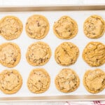 12 baked copycat mrs fields chocolate chip cookies on a baking sheet.
