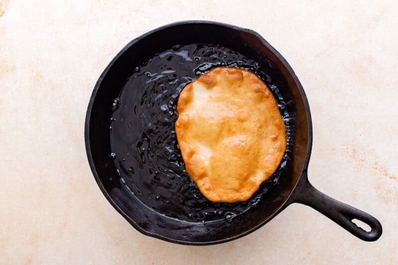 fried elephant ears pastry in a cast iron pan.