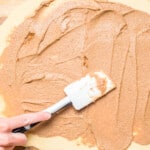 cinnamon filling spread onto estonian kringle dough with a rubber spatula.