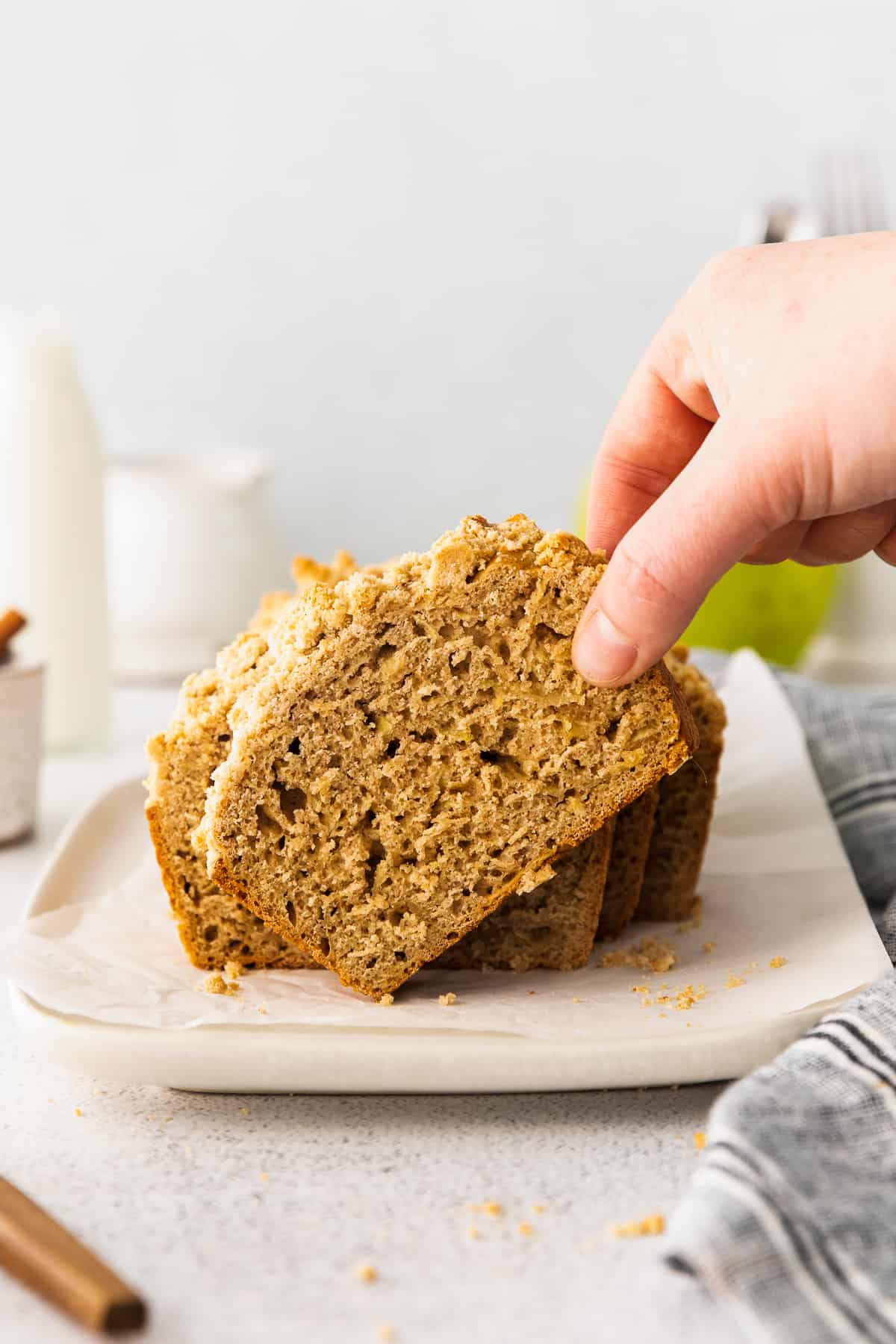 lifting up slice of apple bread