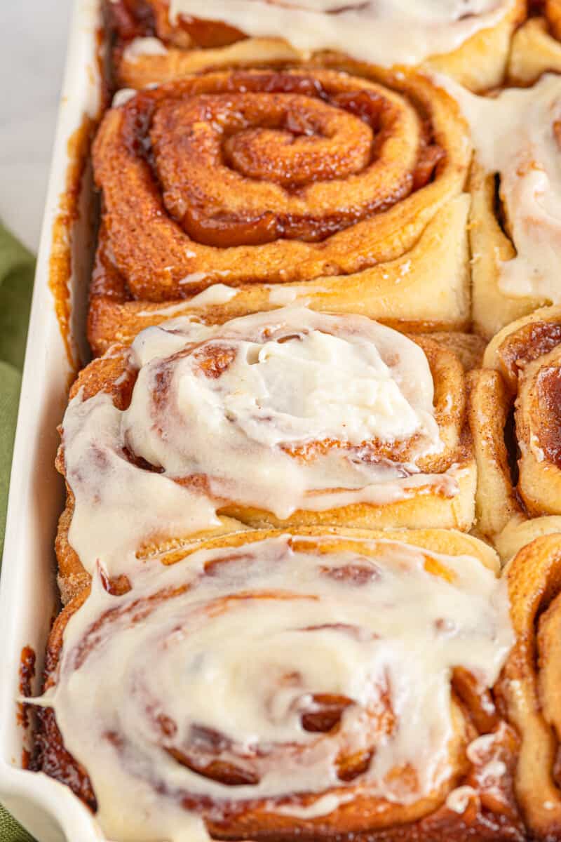 apple pie cinnamon rolls with frosting in pan