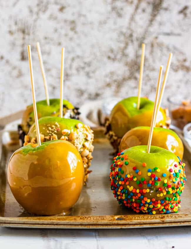 caramel apples on baking sheet