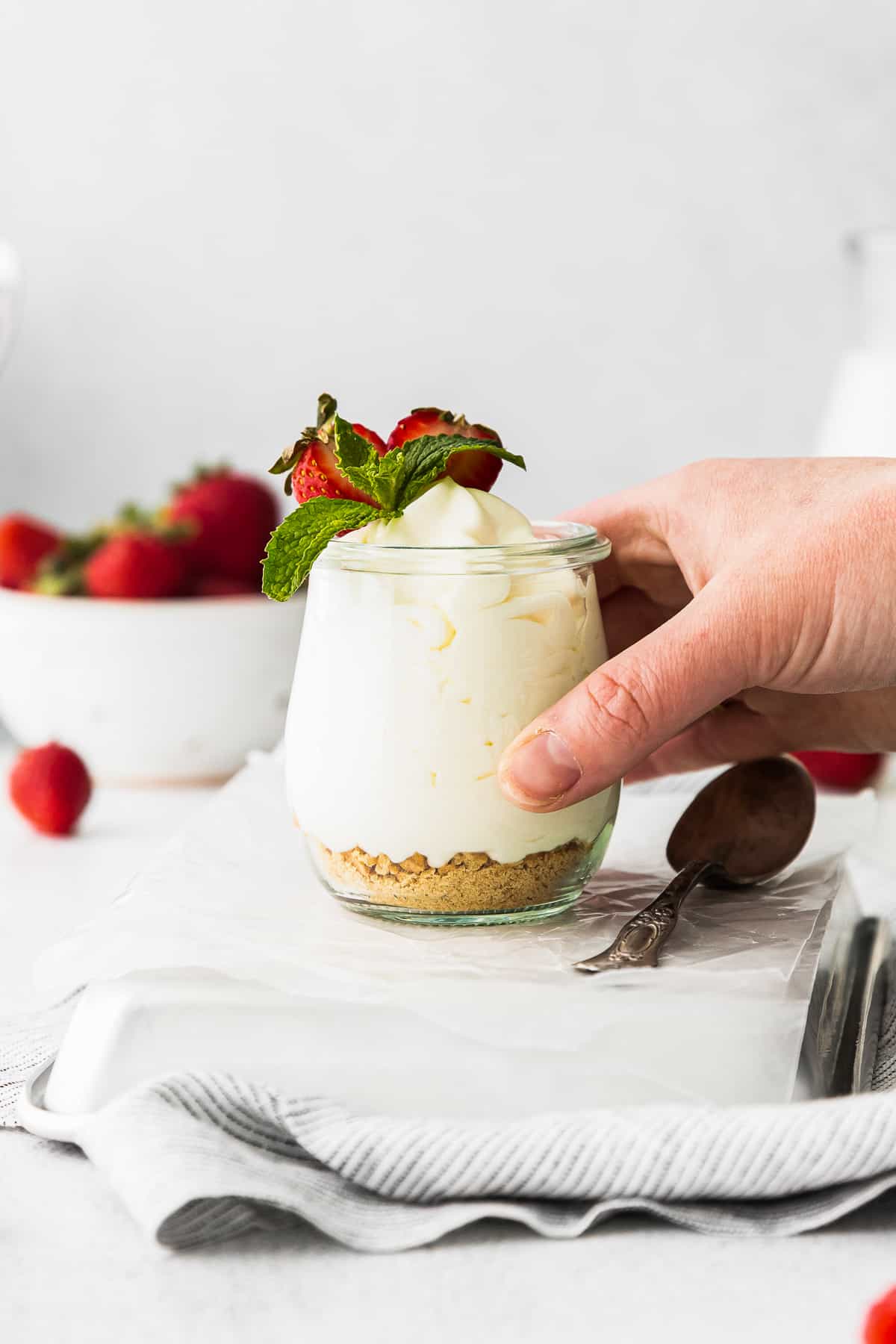 lifting up cheesecake mousse in glass jar
