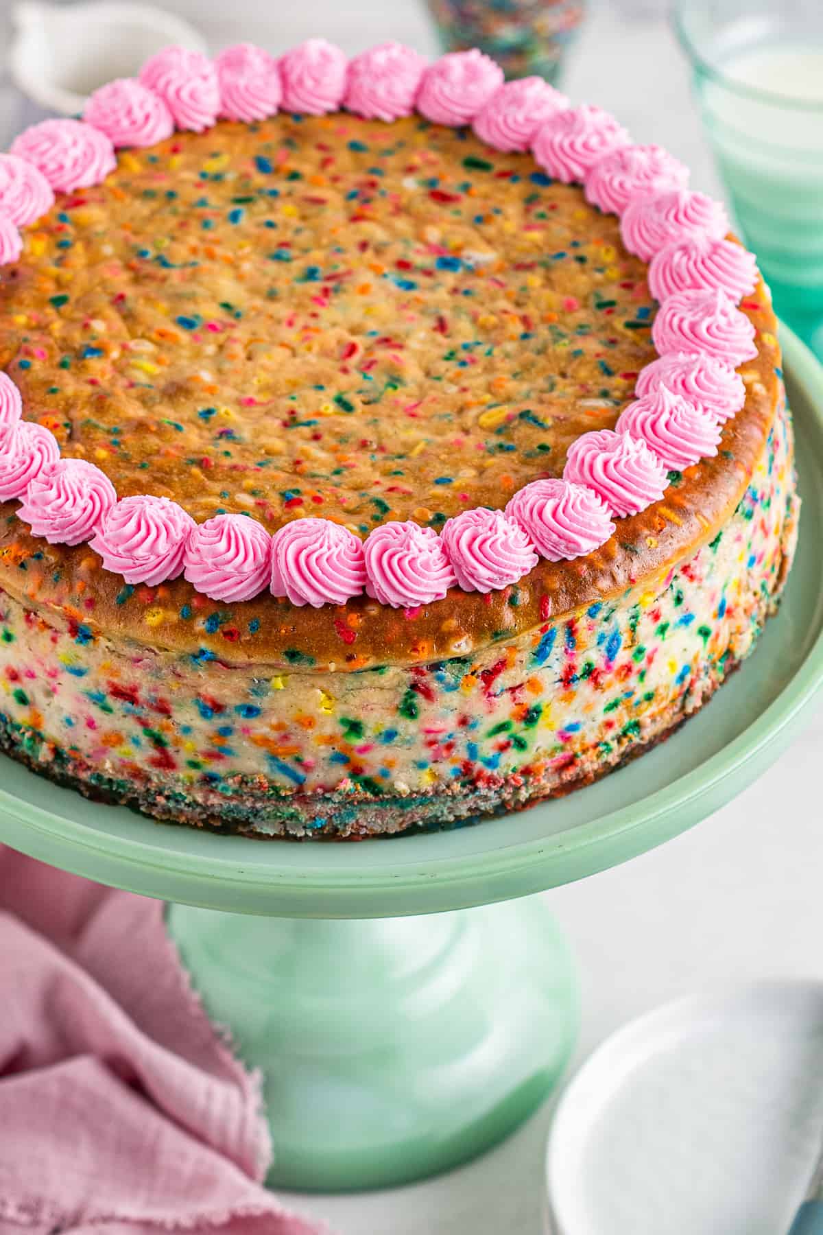 funfetti cheesecake with pink frosting