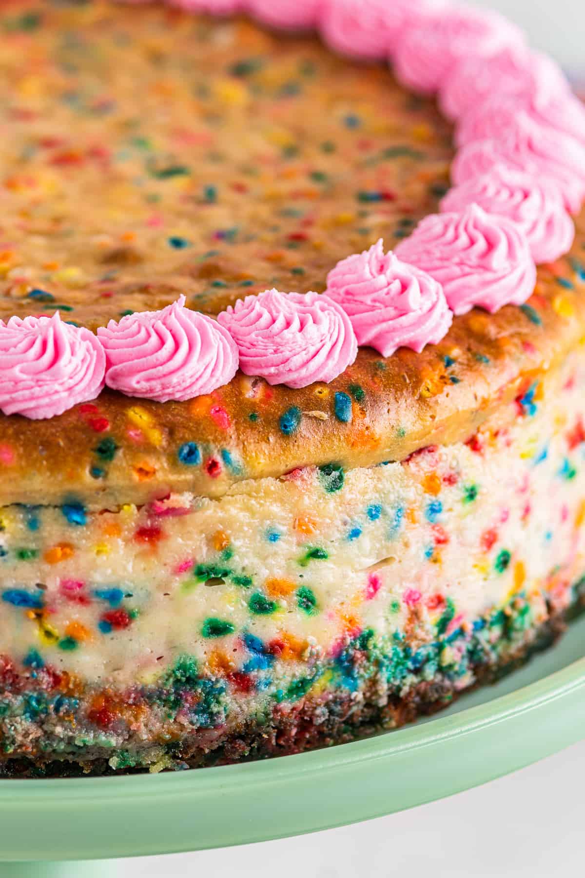 up close funfetti cheesecake with pink frosting