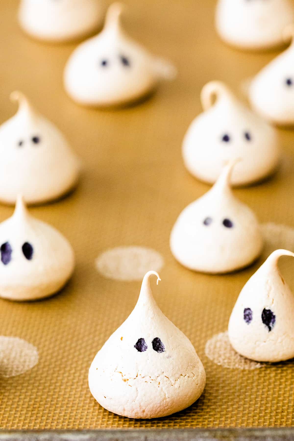 ghost meringue cookies on baking sheet