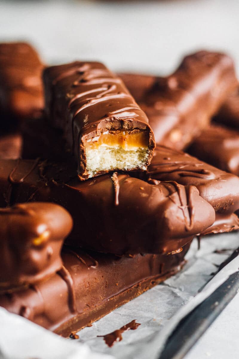 inside of homemade twix bars with chocolate, caramel, and shortbread