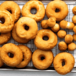 fried donuts on a wire rack.