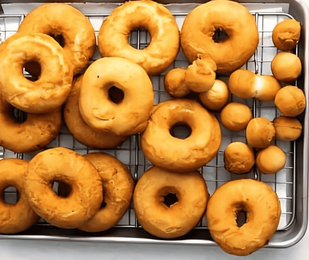 fried donuts on a wire rack.