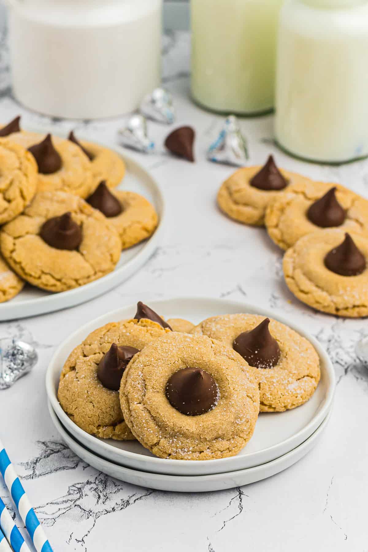 peanut butter kiss cookies on white plates