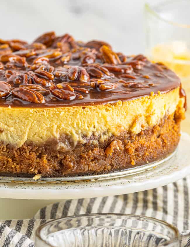 up close pecan pie cheesecake on cake stand