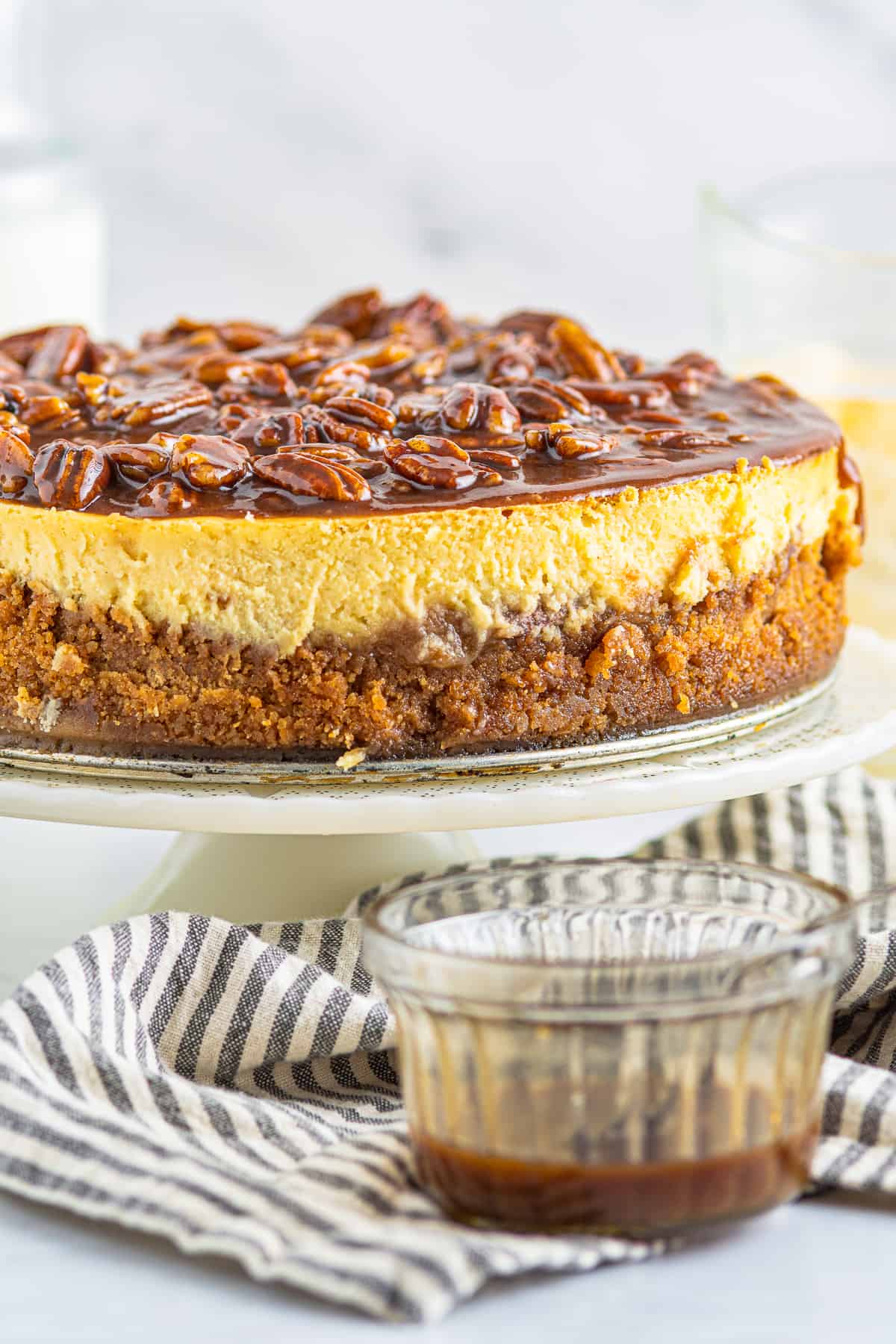 up close pecan pie cheesecake on cake stand