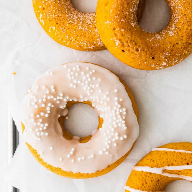 up close baked pumpkin donuts with sprinkles