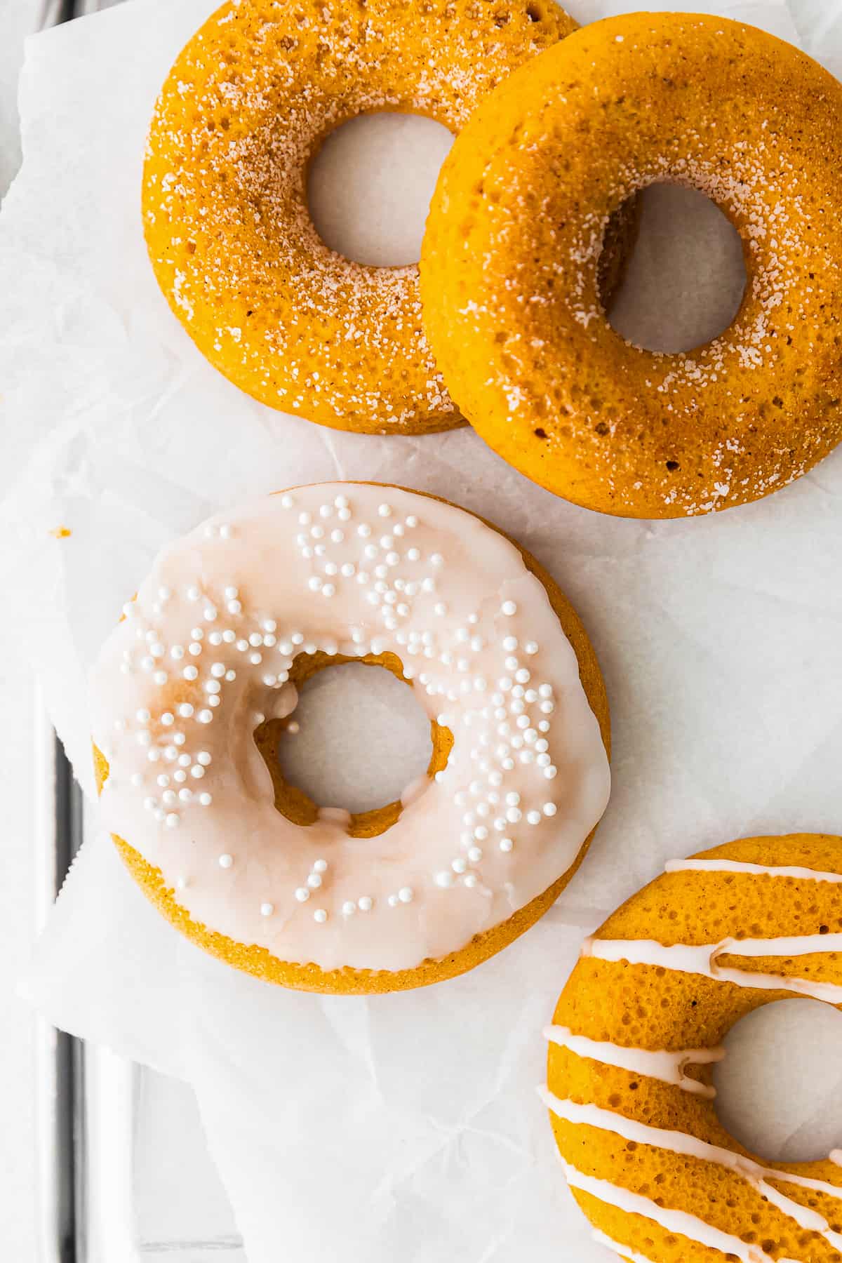 up close baked pumpkin donuts with sprinkles