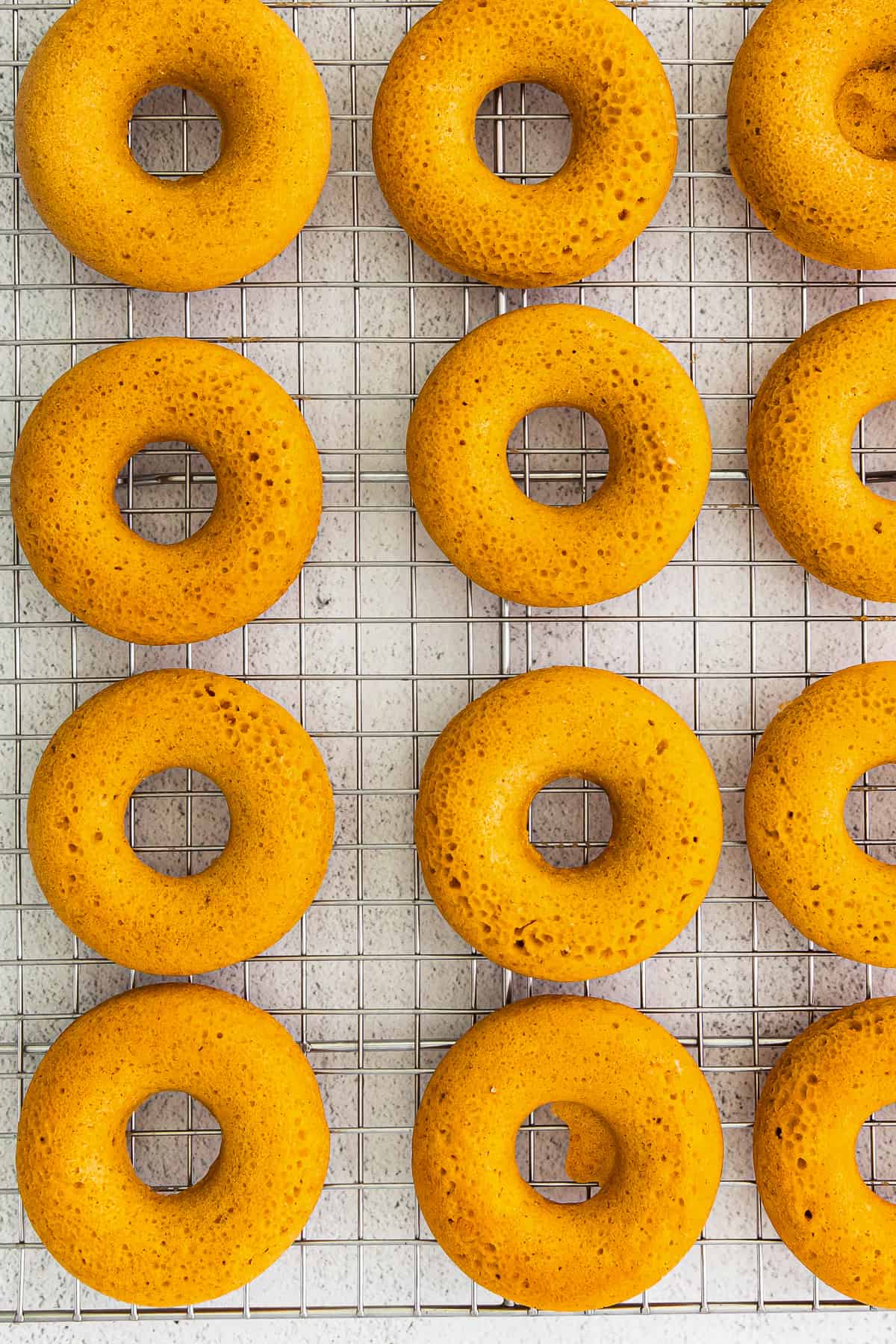 baked pumpkin donuts on cooling rack