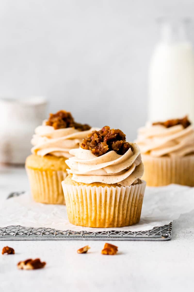 pecan pie cupcakes topped with frosting and pecan pie filling
