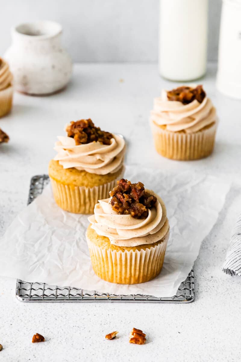 pecan pie cupcakes topped with frosting and pecan pie filling