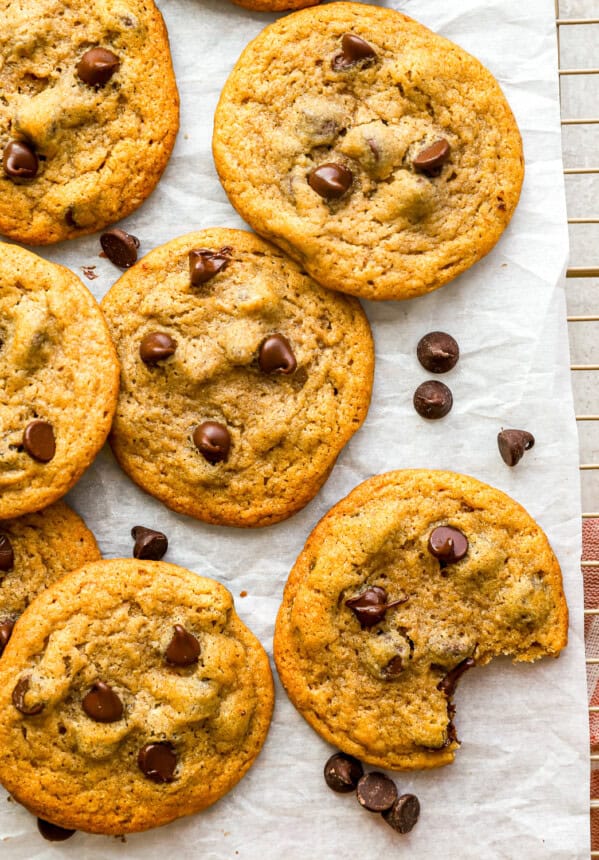 overhead view of pumpkin chocolate chip cookies on parchment paper.