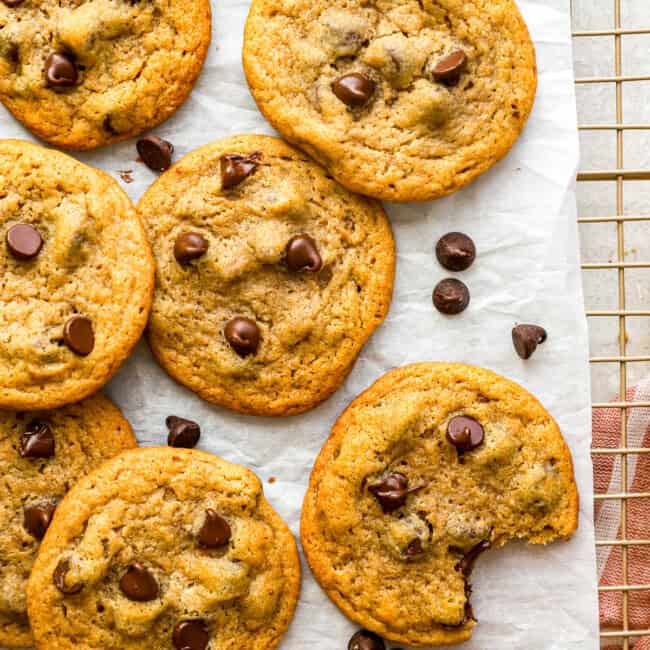 overhead view of pumpkin chocolate chip cookies on parchment paper.