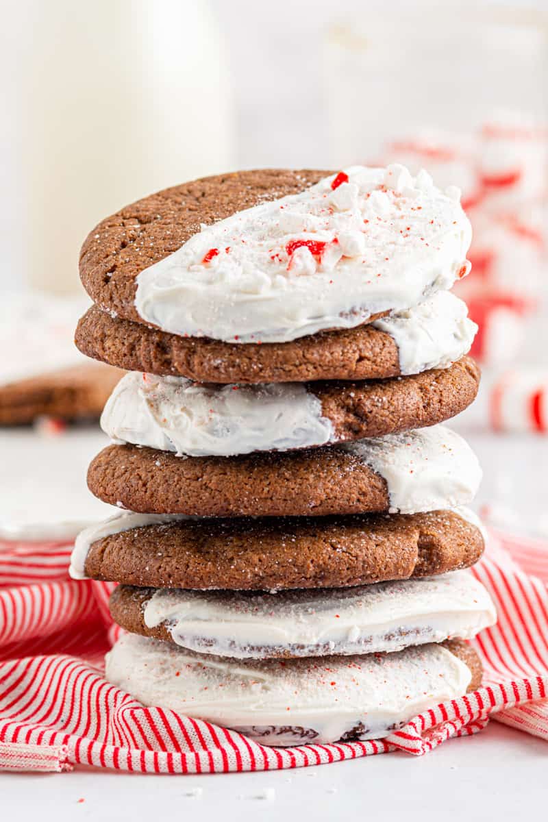 stack of chocolate sugar cookies dipped in white chocolate and sprinkled with crushed peppermint