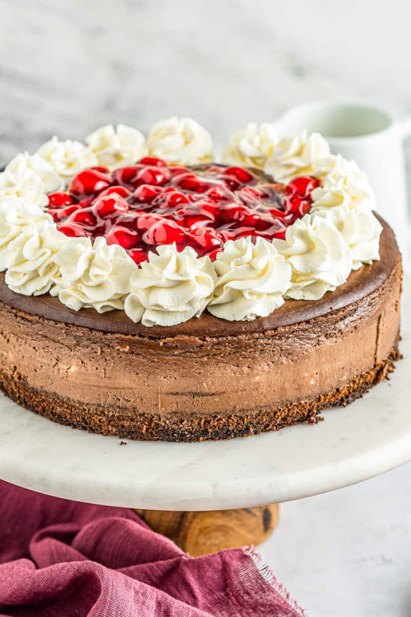 black forest cheesecake on cake stand