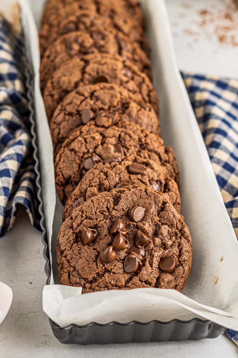 chocolate cookies with chocolate chips in a metal serving container