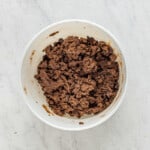 chocolate cake mix cookie dough with chocolate chips after mixing in a white bowl