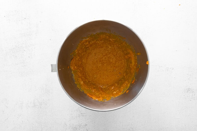 wet ingredients for pumpkin pecan biscotti in a metal bowl