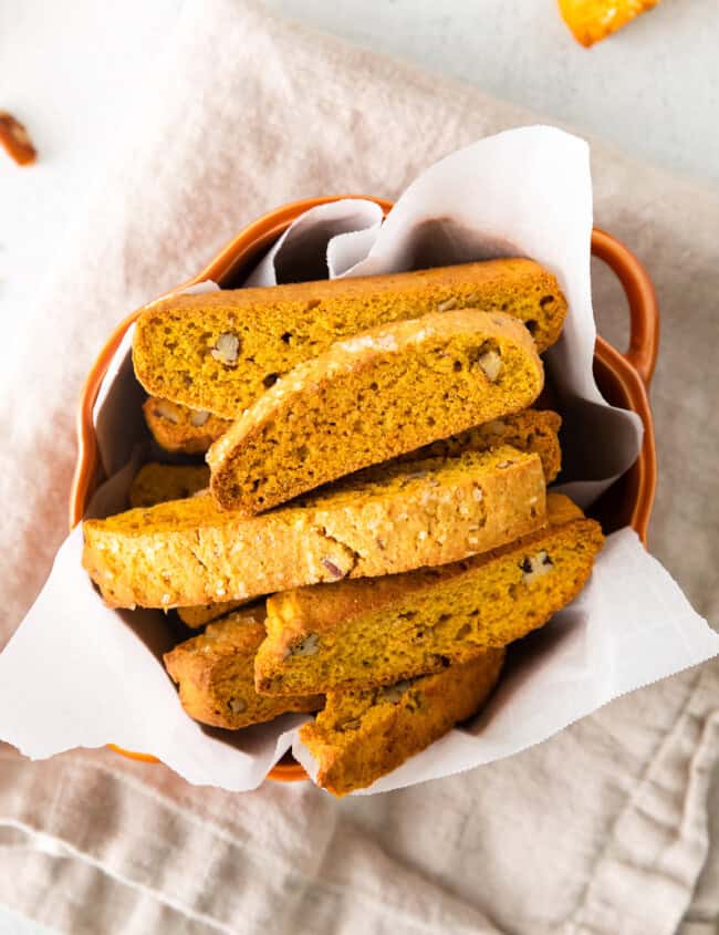 pumpkin pecan biscotti in an orange serving bowl