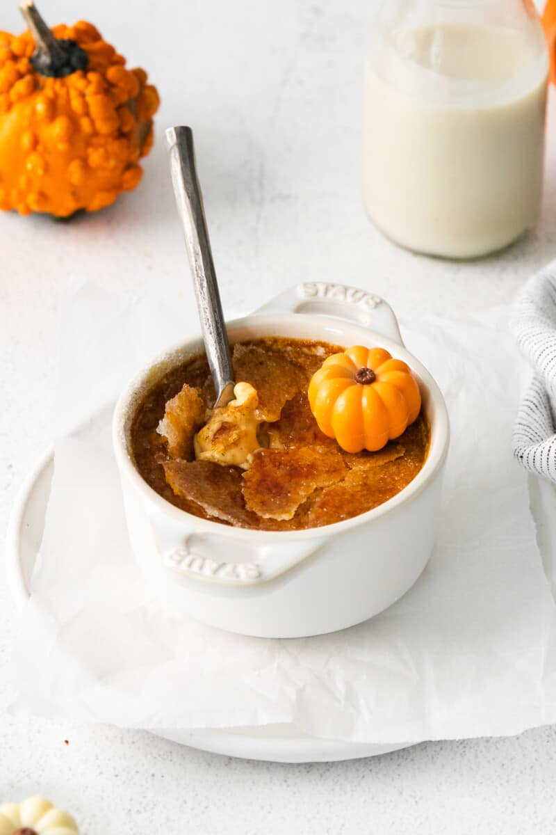 pumpkin creme brulee in a white ramekin with a spoon