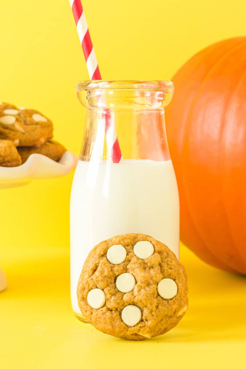 pumpkin pudding cookie and a glass of milk with a straw