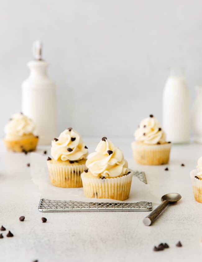 chocolate chip cupcakes topped with frosting and chocolate chips