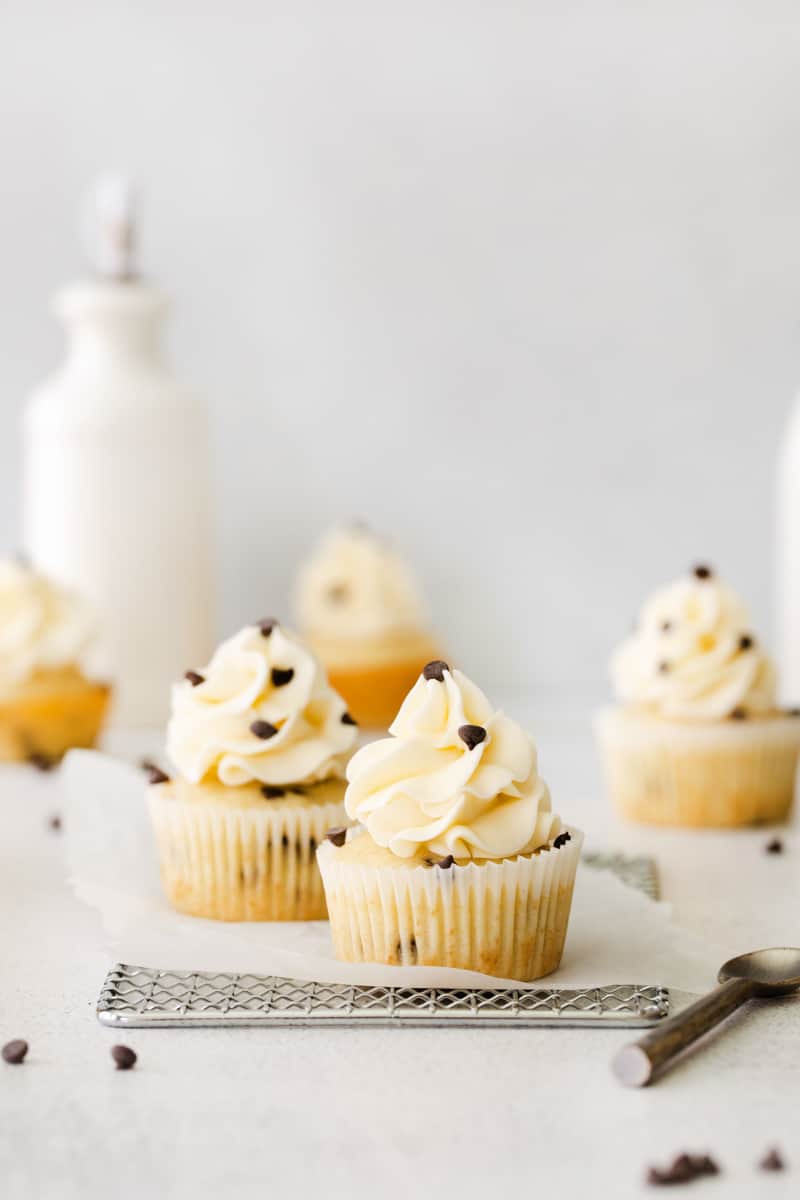 chocolate chip cupcakes topped with frosting and chocolate chips