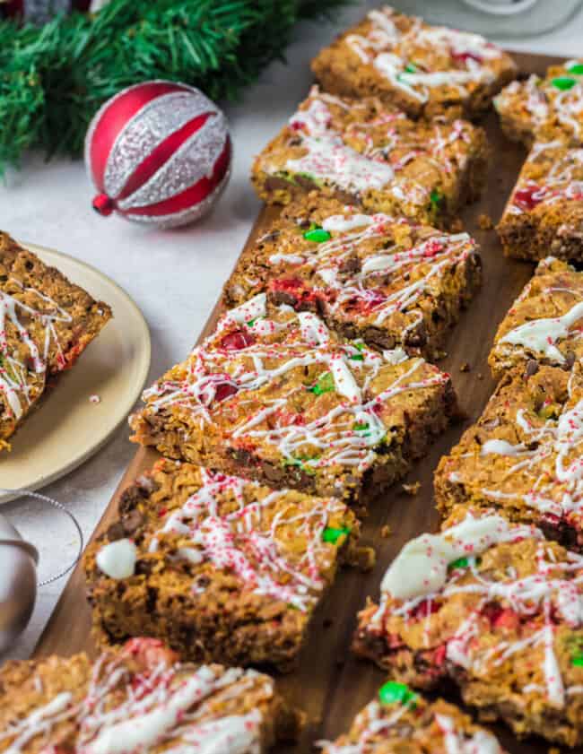 christmas 7 layer magic cookie bars on a wood board